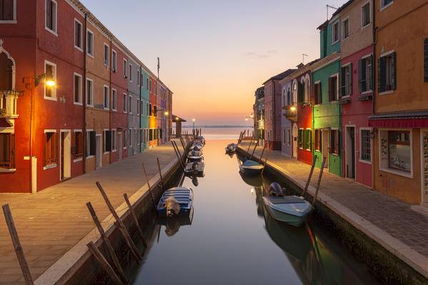 The typical colored houses with Rio di San Mauro Canal at sunset, Burano Island, Venice, Veneto, Italy.