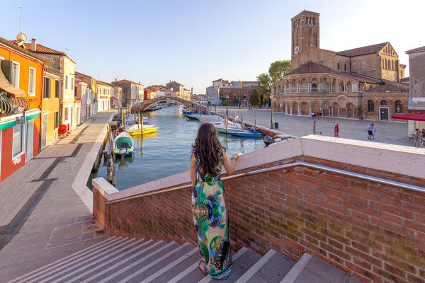 A woman admires the Church of Santa Maria e San Donato (Murano Cathedral), Murano Island, Venice, Veneto, Italy.