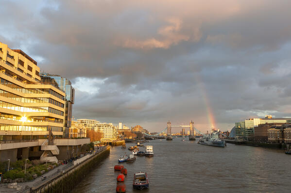 Tower Bridge and HMS Belfast from London Bridge at sunset with rainbow, London, Great Britain, UK