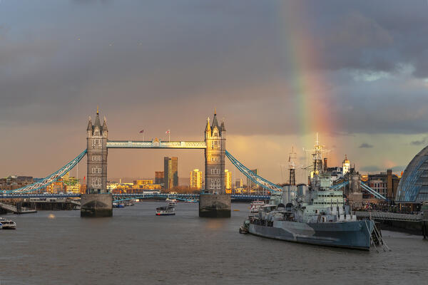 Tower Bridge and HMS Belfast from London Bridge at sunset with rainbow, London, Great Britain, UK