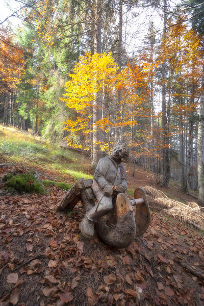Wood sculpure in the woods of Talagona Valley, Dolomites, Pieve di Cadore, Belluno province, Veneto, Italy.