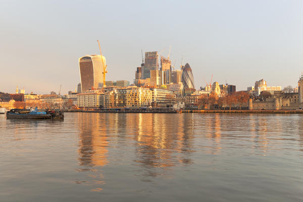 City of London reflected on rivers Thames at sunrise, London, Great Britain, UK