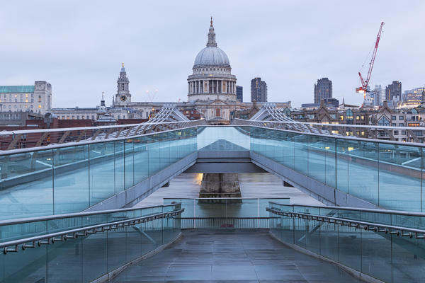 St. Paul’s Cathedral from Millennium Bridge during a cloudy dawn, London, Great Britain, UK