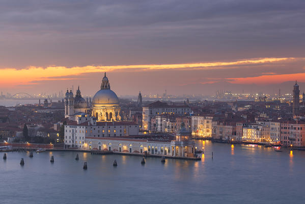 View of Punta della Dogana with church of Santa Maria della Salute from the bell tower of abbey of San Giorgio Maggiore at dusk, Venice, Veneto, Italy