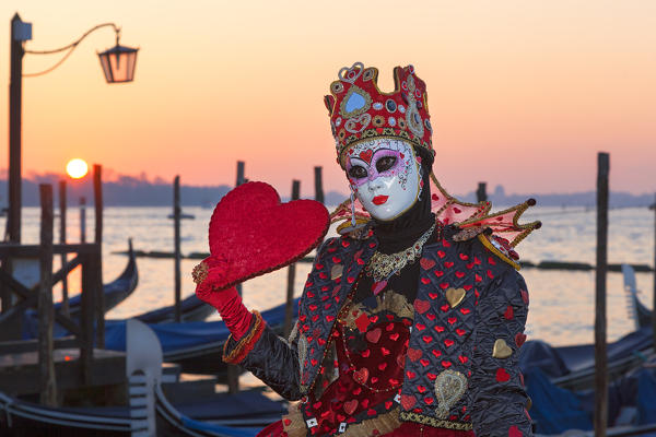 Typical mask of Carnival of Venice in Riva degli Schiavoni at sunrise, Venice, Veneto, Italy
