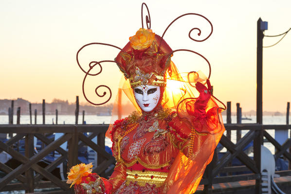 Typical mask of Carnival of Venice in Riva degli Schiavoni at sunrise, Venice, Veneto, Italy
