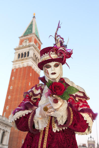 Typical mask of Carnival of Venice with San Marco Bell Tower on background, Venice, Veneto, Italy