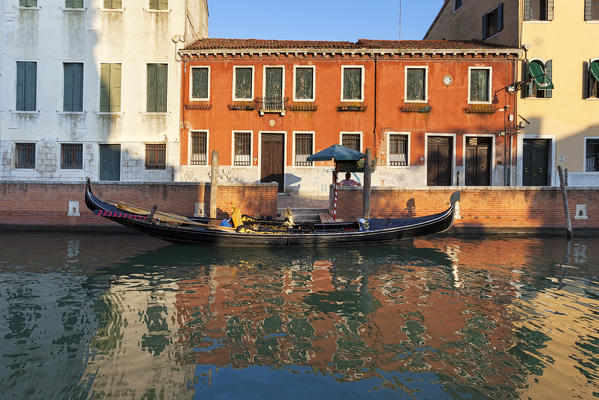 A typical gondola with its gondolier, Rio di San Trovaso, Venice, Veneto, Italy