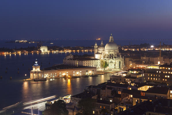 Santa Maria della Salute and Punta della Dogana seen from the top of St. Mark's Campanile by night, Venice, Veneto, Italy.