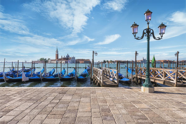 Gondolas of Venice in Riva degli Schiavoni with St. George's island in the background, Venice, Veneto, Italy