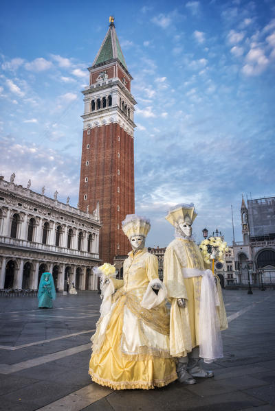Typical mask of Carnival of Venice with the bell tower of St. Mark in the background, Venice, Veneto, Italy