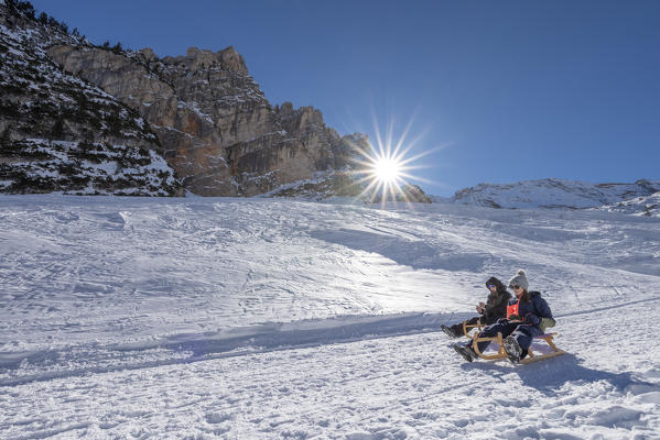 San Vigilio di Marebbe, Fanes, Dolomites, South Tyrol, Italy, Europe. Children sled down from the refuge Fanes