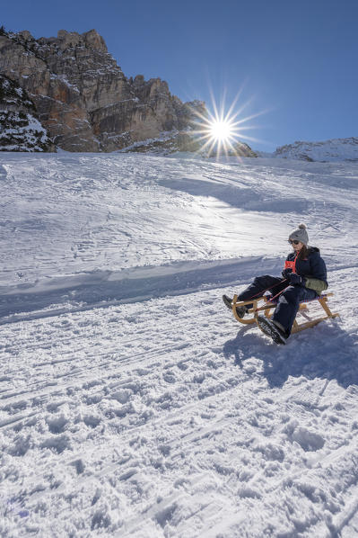 San Vigilio di Marebbe, Fanes, Dolomites, South Tyrol, Italy, Europe. Child sled down from the refuge Fanes