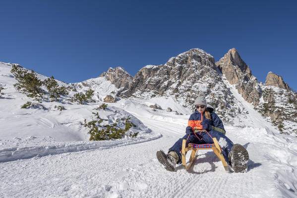 San Vigilio di Marebbe, Fanes, Dolomites, South Tyrol, Italy, Europe. Child sled down from the refuge Fanes