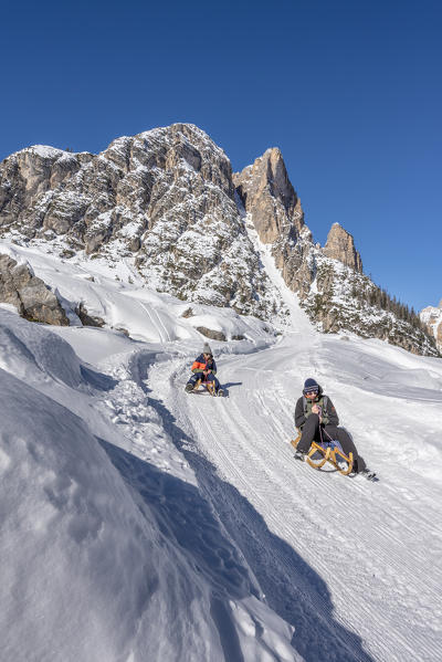 San Vigilio di Marebbe, Fanes, Dolomites, South Tyrol, Italy, Europe. Children sled down from the refuge Fanes