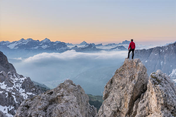 Gran Cir, Gardena Pass, Dolomites, Bolzano district, South Tyrol, Italy, Europe. A mountaineer admires the sunrise at the summit of the Gran Cir (MR)