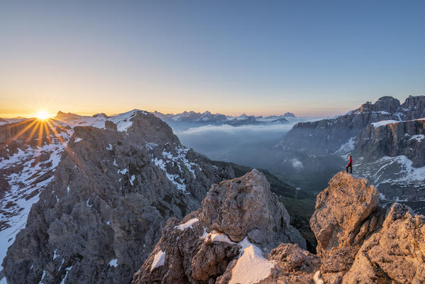 Gran Cir, Gardena Pass, Dolomites, Bolzano district, South Tyrol, Italy, Europe. A mountaineer admires the sunrise at the summit of the Gran Cir (MR)