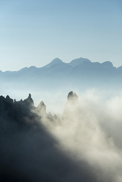 Gardena Pass, Dolomites, Bolzano district, South Tyrol, Italy, Europe. Fog drifts around some crags, in the background the mountains of Tofana di Mezzo and Tofana di Dentro
