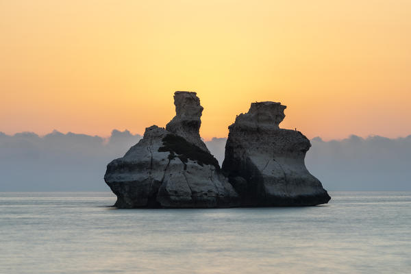 Torre dell'Orso, Melendugno, province of Lecce, Salento, Apulia, Italy, Europe. The Due Sorelle (Two Sisters) at sunrise