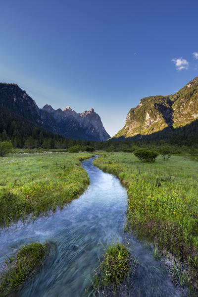 Dobbiaco/Toblach, Dolomites, South Tyrol, Italy. The Rienz brook in the Landro valley with the peak of Croda Bagnata at sunrise