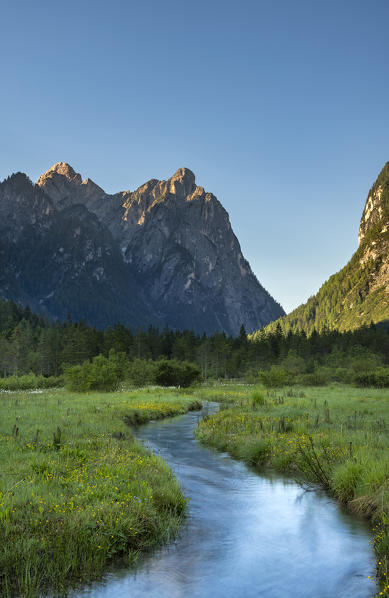 Dobbiaco/Toblach, Dolomites, South Tyrol, Italy. The Rienz brook in the Landro valley with the peak of Croda Bagnata at sunrise