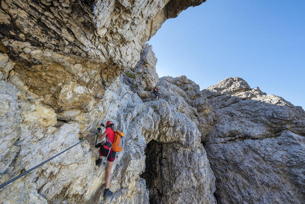 Falzarego Pass, Dolomites, province of Belluno, Veneto, Italy. Mountaineers on the via ferrata 