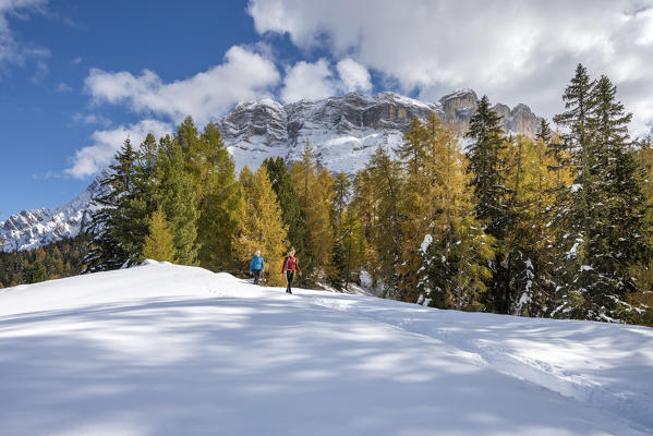 Alta Badia, Bolzano province, South Tyrol, Italy, Europe. Hikers on the Armentara meadows, above the mountains of the Neuner, Zehner and Heiligkreuzkofel