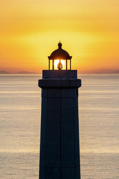 Otranto, province of Lecce, Salento, Apulia, Italy. Sunrise at the lighthouse Faro della Palascìa. This lighthouse marks the most easterly point of the Italian mainland.  In the background you can see mountains of Albania