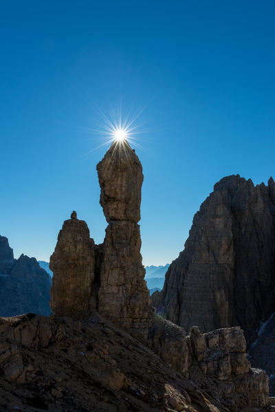 Auronzo, Dolomites, Veneto, Italy. Star sun exactly on the summit of Salsiccia near Refuge Carducci