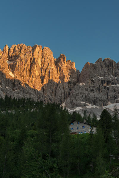 Sorapiss Lake, Dolomites, Veneto, Italy. Sunset in the Sorapiss group. Behind the Refuge Vandelli take the last sunrays on the Tre Sorelle (three sisters)