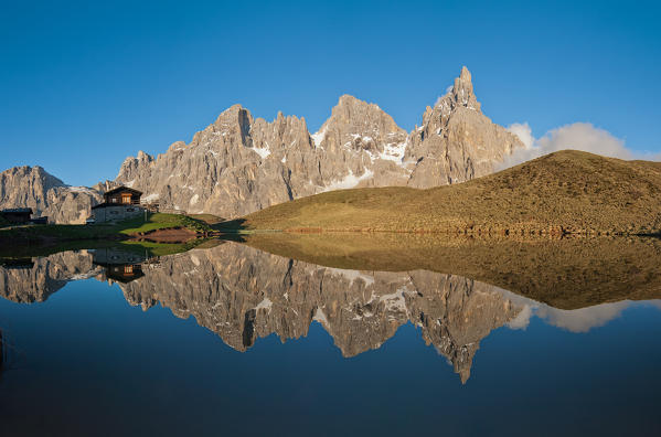 Passo Rolle, Dolomites, Trentino, Italy. The mountaingroup of Pala di San Martino  reflecting in the lake near Segantini Hut. From left Mulaz, Cima dei Bureloni, Cima Vezzana and Cimon della Pala.