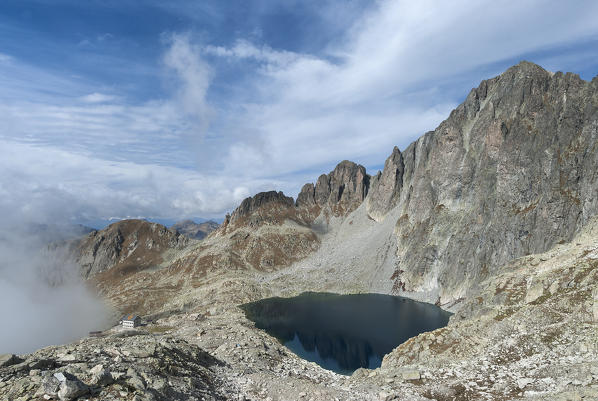 Cima d'Asta, Trentino, Italy. The Cima d'Asta (2847m). Under the rockwall the lake of Cima d'Asta and the refuge Ottone Brentari