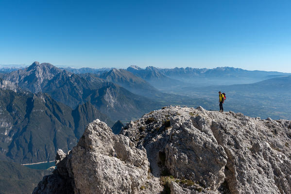 Mount Pizzocco, Dolomites, Veneto, Italy. Mountaineer on the summit of Pizzocco, National Park Dolomiti Bellunesi