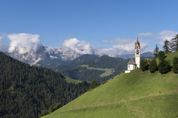 La Val/Wengen, Dolomites, South Tyrol, Italy. The Church of Santa Barbara in La Val with the Puez mountain Group in the background