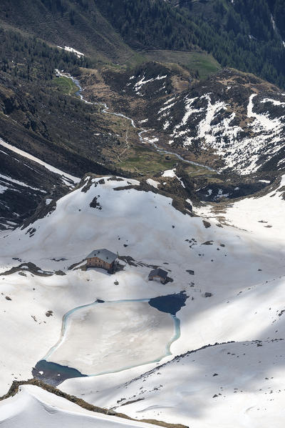 Terento, South Tyrol, Italy. The refuge Lago di Pausa / Tiefrastenhuette and the frozen lake