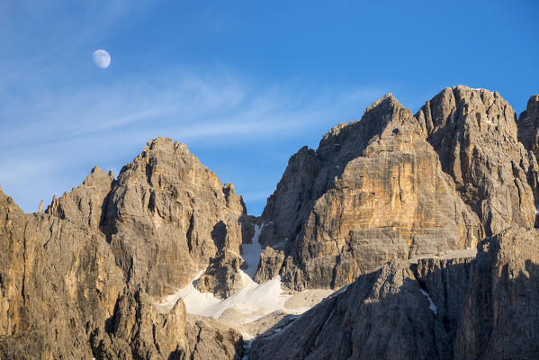 Sella, Dolomites, South Tyrol, Italy. The moon over the peak od Sas da Lech