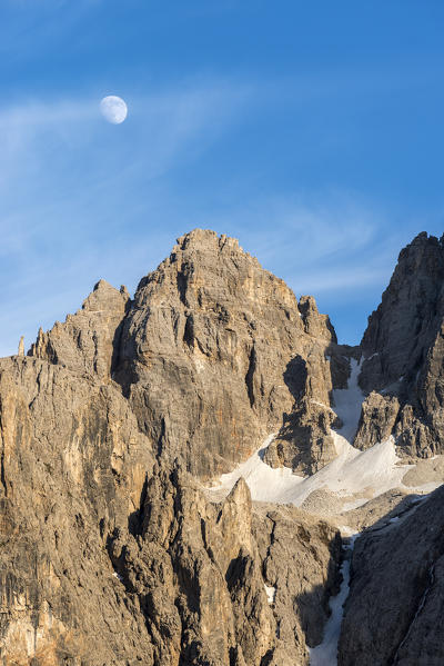 Sella, Dolomites, South Tyrol, Italy. The moon over the peak od Sas da Lech