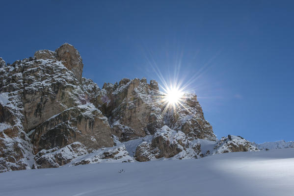 Fanes, Dolomites, South Tyrol, Italy. The sun rises behind the peaks of Piciodel