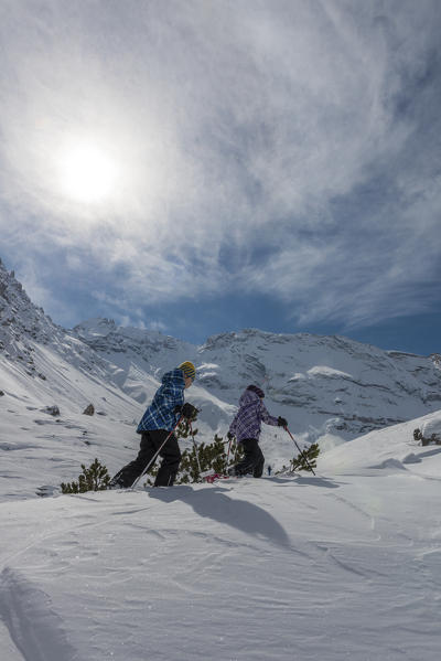 Fanes, Dolomites, South Tyrol, Italy. Children wearing snowshoes walking in the mountains of the Fanes