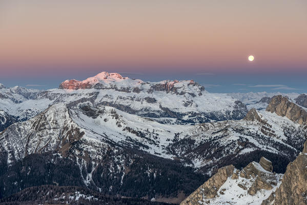 Nuvolau, Dolomites, Veneto, Italy. Twilight and full moon in the Dolomites with the peaks of Sella mountain group