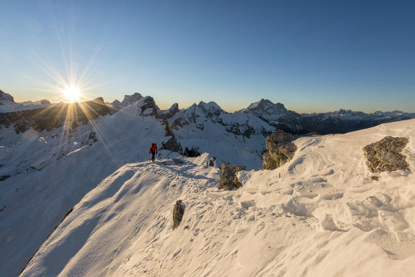 Nuvolau, Dolomites, Veneto, Italy. Mountaineer on the ridge to the summit of Nuvolau.