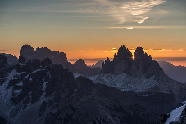 Picco di Vallandro, Prato Piazza, Dolomites, South Tyrol, Italy. The sun rises exactly in between the crags of the Tre Cime di Lavaredo. This effect occurs only few days per year, exactly during winter solstice days