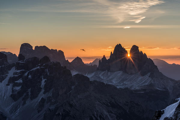 Picco di Vallandro, Prato Piazza, Dolomites, South Tyrol, Italy. The sun rises exactly in between the crags of the Tre Cime di Lavaredo. This effect occurs only few days per year, exactly during winter solstice days