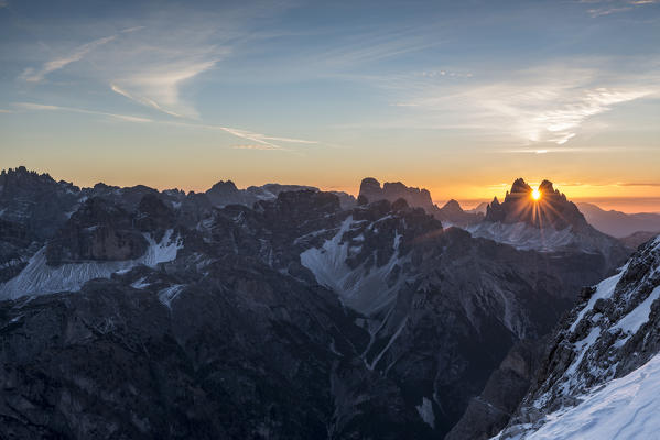 Picco di Vallandro, Prato Piazza, Dolomites, South Tyrol, Italy. The sun rises exactly in between the crags of the Tre Cime di Lavaredo. This effect occurs only few days per year, exactly during winter solstice days