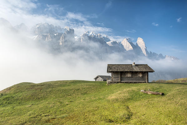 Passo Gardena, Dolomites, South Tyrol, Italy. Mountain hut in front of the mountains of the Sella group