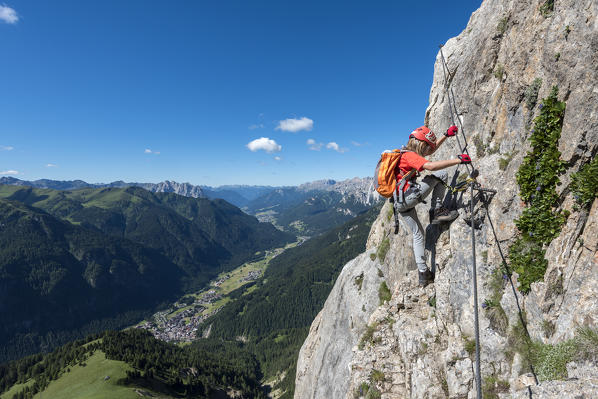 Col Rodella, Dolomites, Trentino, Italy. Climber on the via ferrata to the summit of Col Rodella