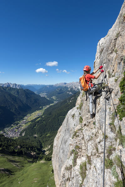 Col Rodella, Dolomites, Trentino, Italy. Climber on the via ferrata to the summit of Col Rodella