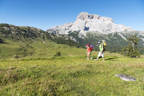 Prato Piazza/Plätzwiese, Dolomites, South Tyrol, Italy. Two children hike over the Prato Piazza/Plätzwiese. In the background the Croda Rossa/Hohe Gaisl