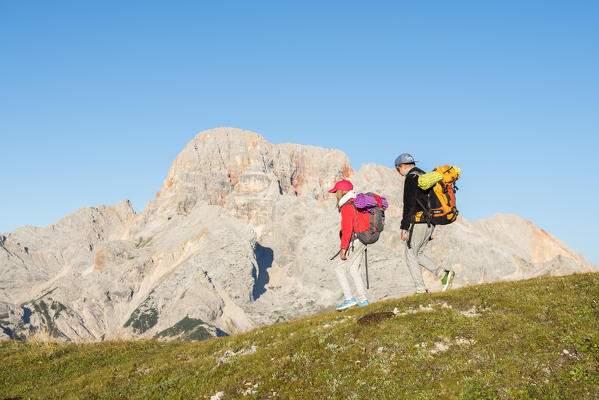 Prato Piazza/Plätzwiese, Dolomites, South Tyrol, Italy. Two children hike over the Prato Piazza/Plätzwiese. In the background the Croda Rossa/Hohe Gaisl