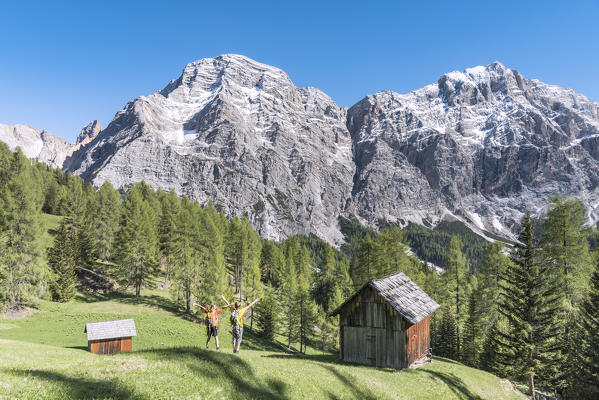 La Valle / Wengen, Alta Badia, Bolzano province, South Tyrol, Italy. Hikers traveling on the pastures of Pra de Rit